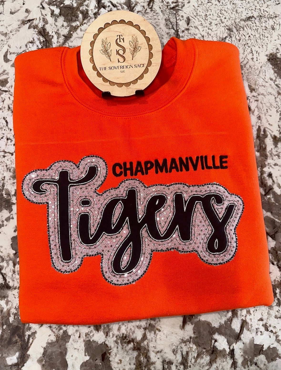 Orange crewneck with pink Chapmanville Tigers appliqué