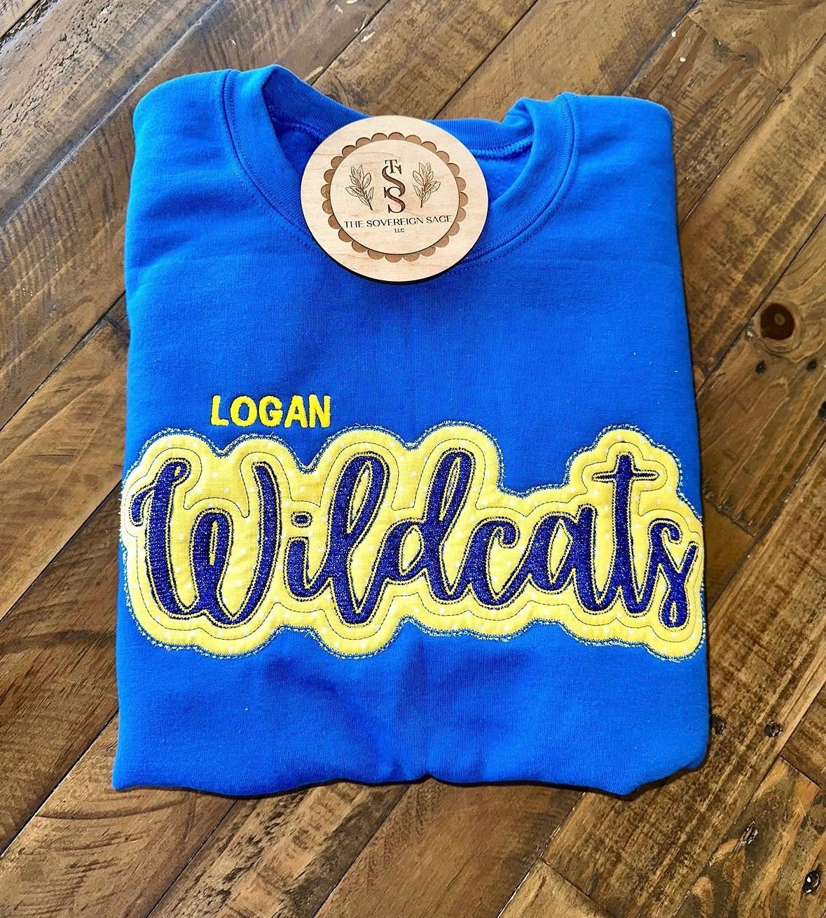 Blue crewneck with yellow Logan Wildcats appliqué